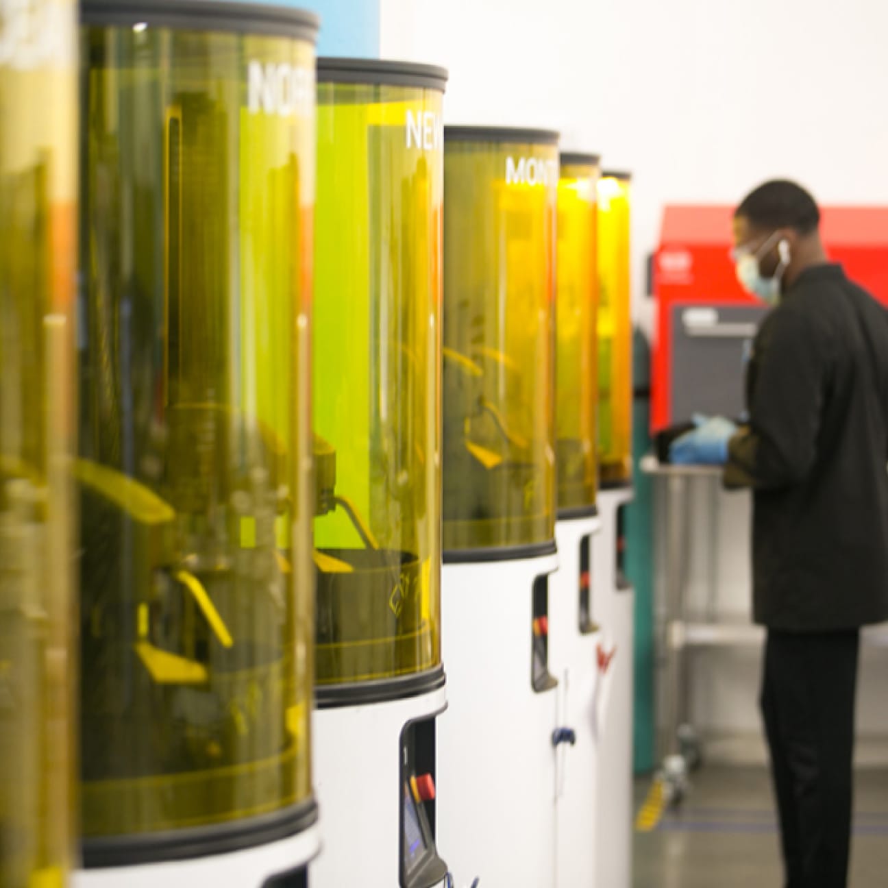Man operating carbon 3d printers